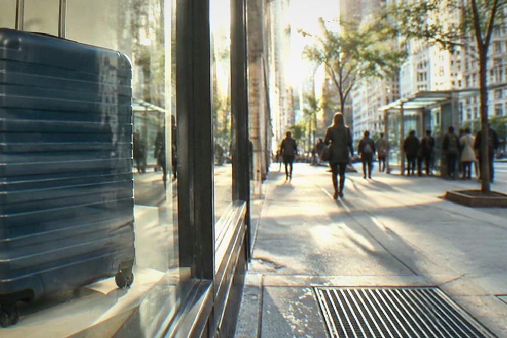 Street view of a Midtown Manhattan storefront with a luggage storage sign in the window