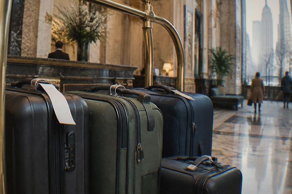 Bell stand in a hotel lobby with tagged suitcases lined up behind the counter