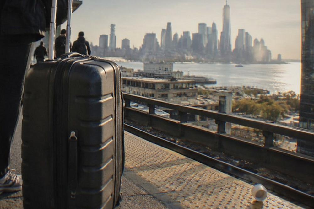 View across the Hudson River toward the Manhattan skyline from a rail station platform