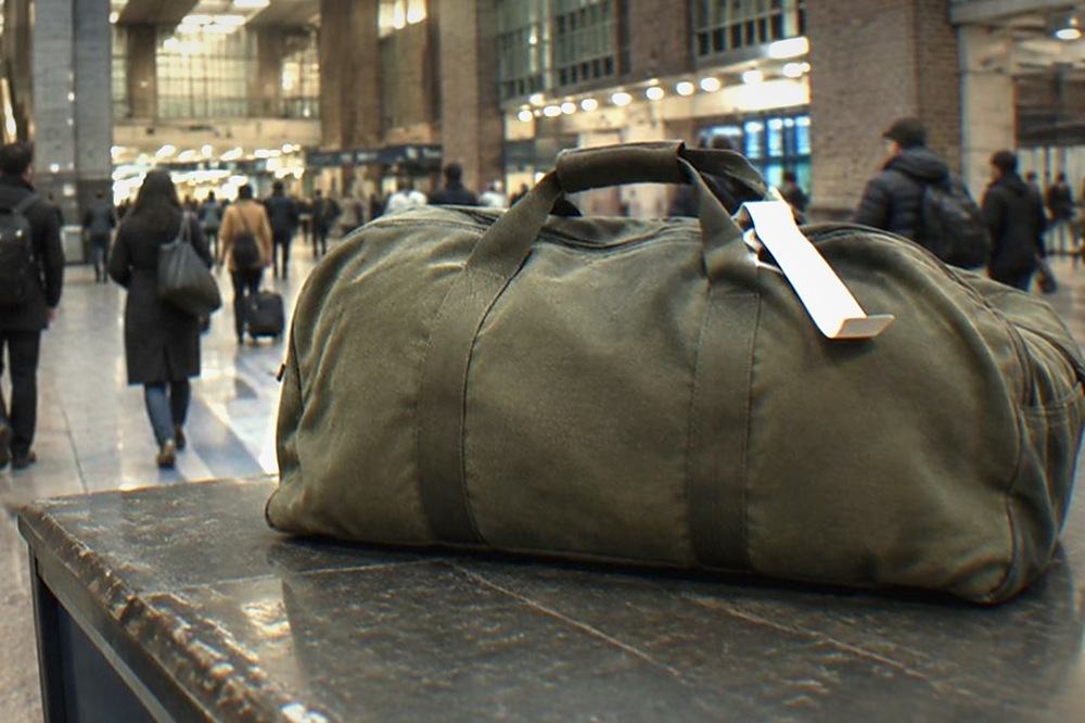 Train station concourse with a service desk and passengers walking with small bags