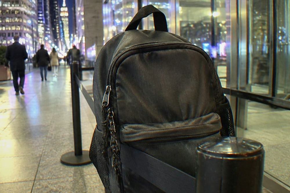 A roped-off security checkpoint lane beside a glass arena entrance in Midtown Manhattan