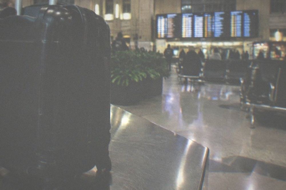 Train station concourse with wide departures board and open seating