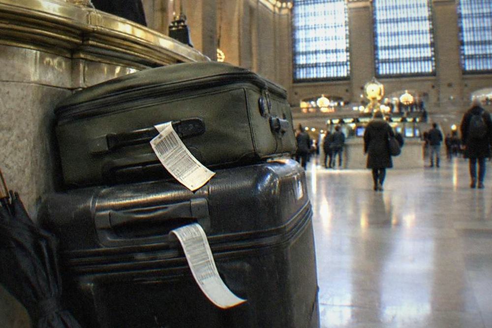 Bell desk counter with tagged luggage tickets and stacked suitcases behind the counter