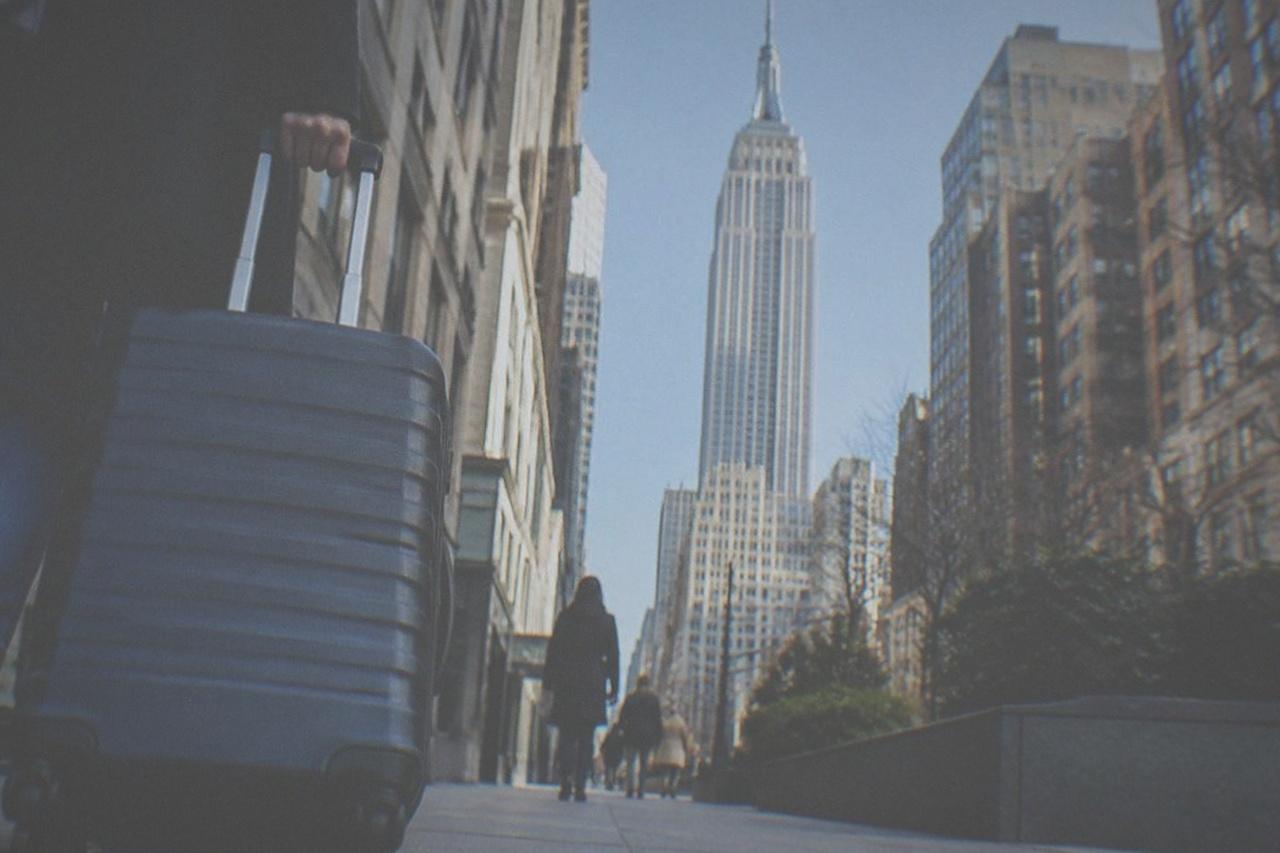 The Empire State Building rising above Midtown Manhattan rooftops on a clear day