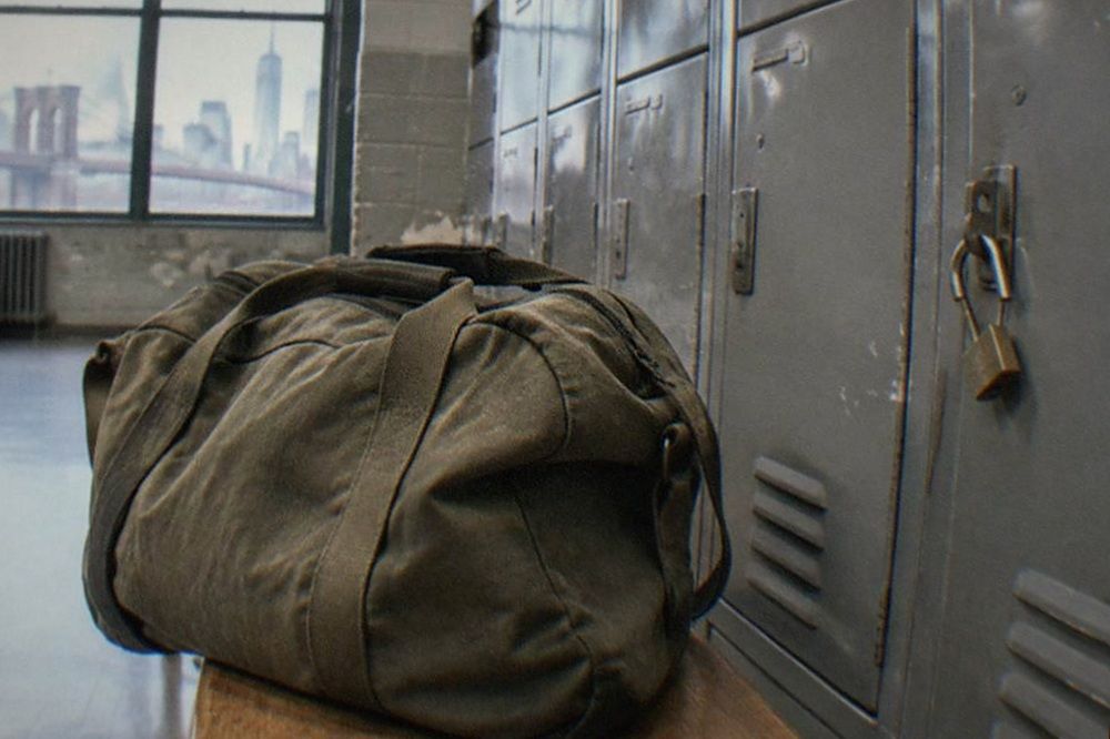 Bank of grey metal lockers with number plates inside a recreation centre hallway