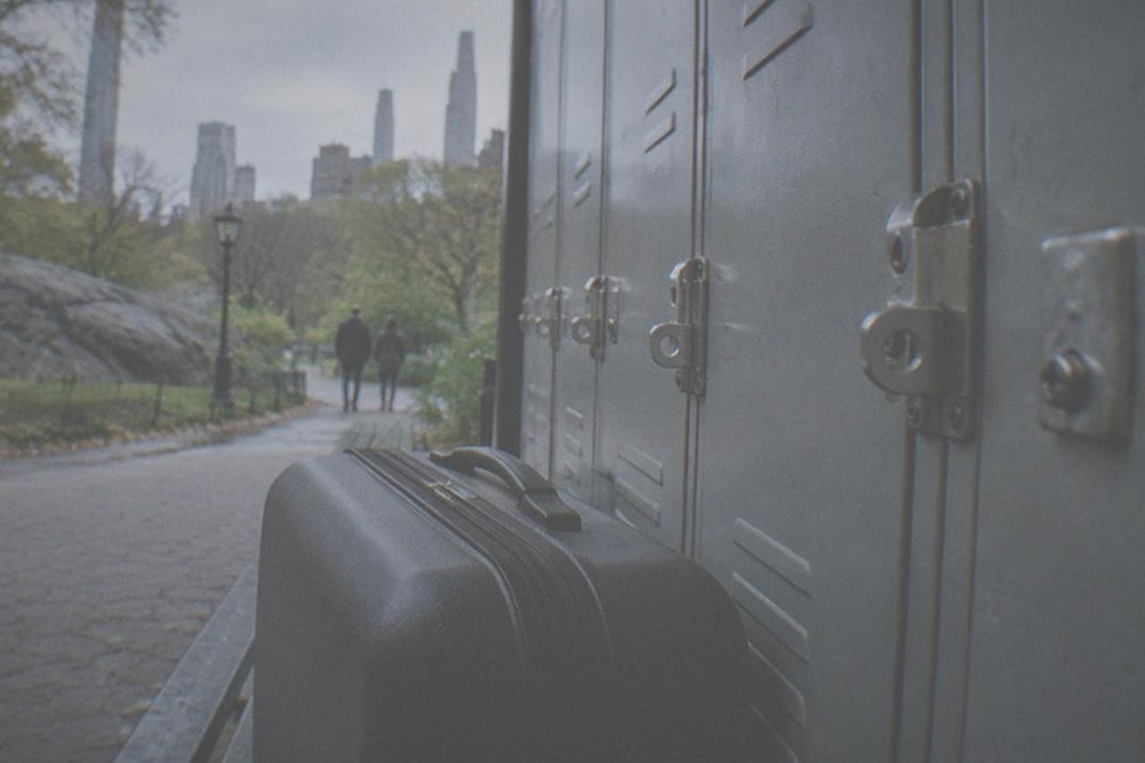Row of empty metal lockers with combination latches along a quiet interior wall
