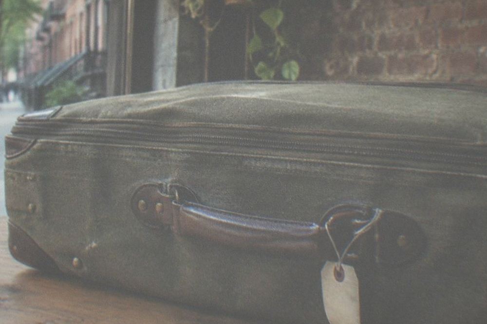 Suitcase waiting beside the counter of a small shop interior