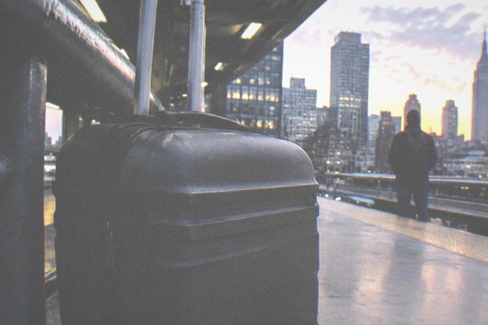 An airport train platform at dusk with an empty space where luggage would stand